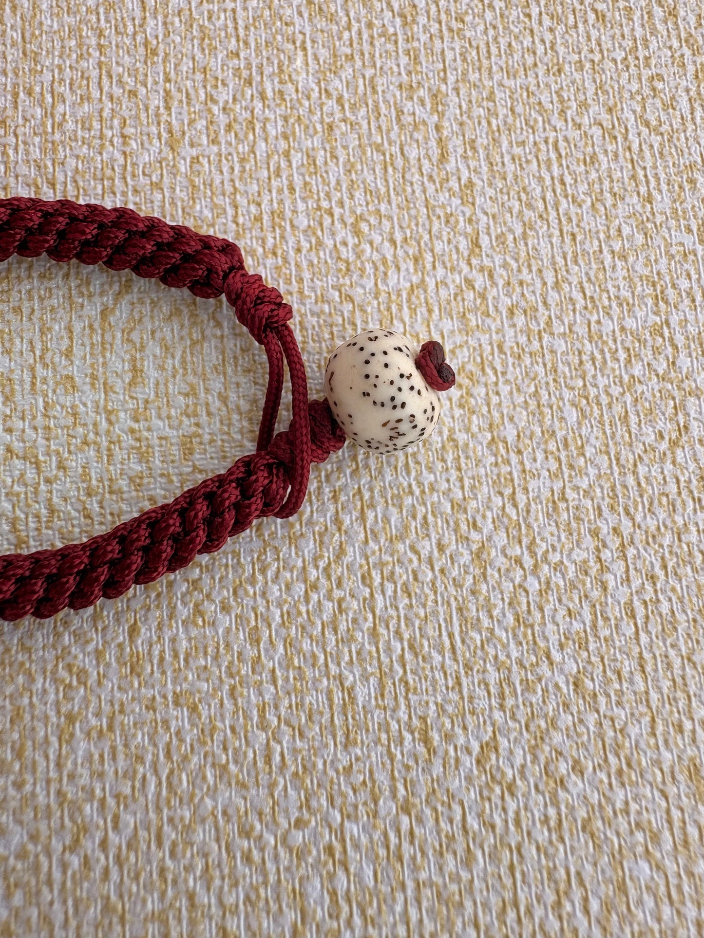 Small Mahakala Thangka Charm with Prayer Wheel Tassel in Tibetan Red