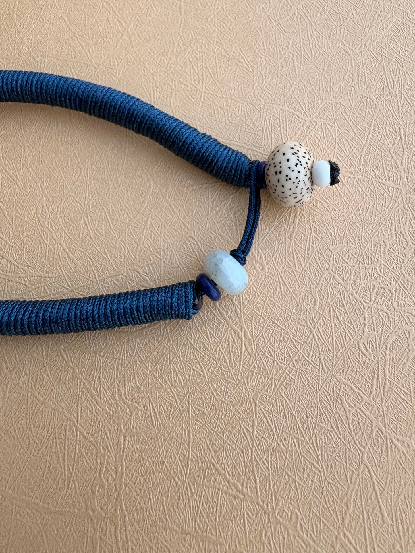Yellow Jambhala Thangka Charm with Jade Tassel in Deep Tibetan Blue