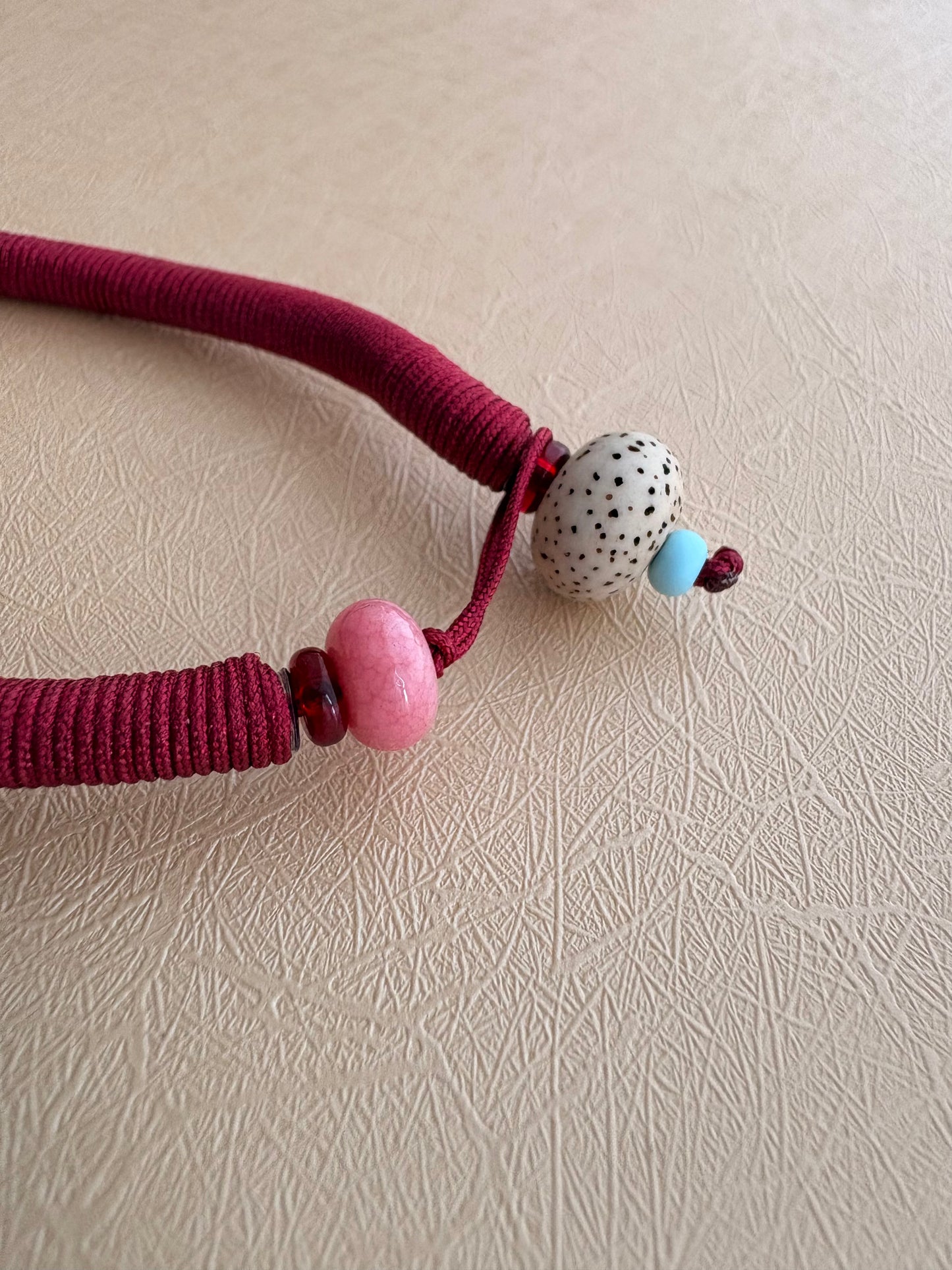 Zaki Lhamo Thangka Charm with Jade Tassel in Tibetan Red