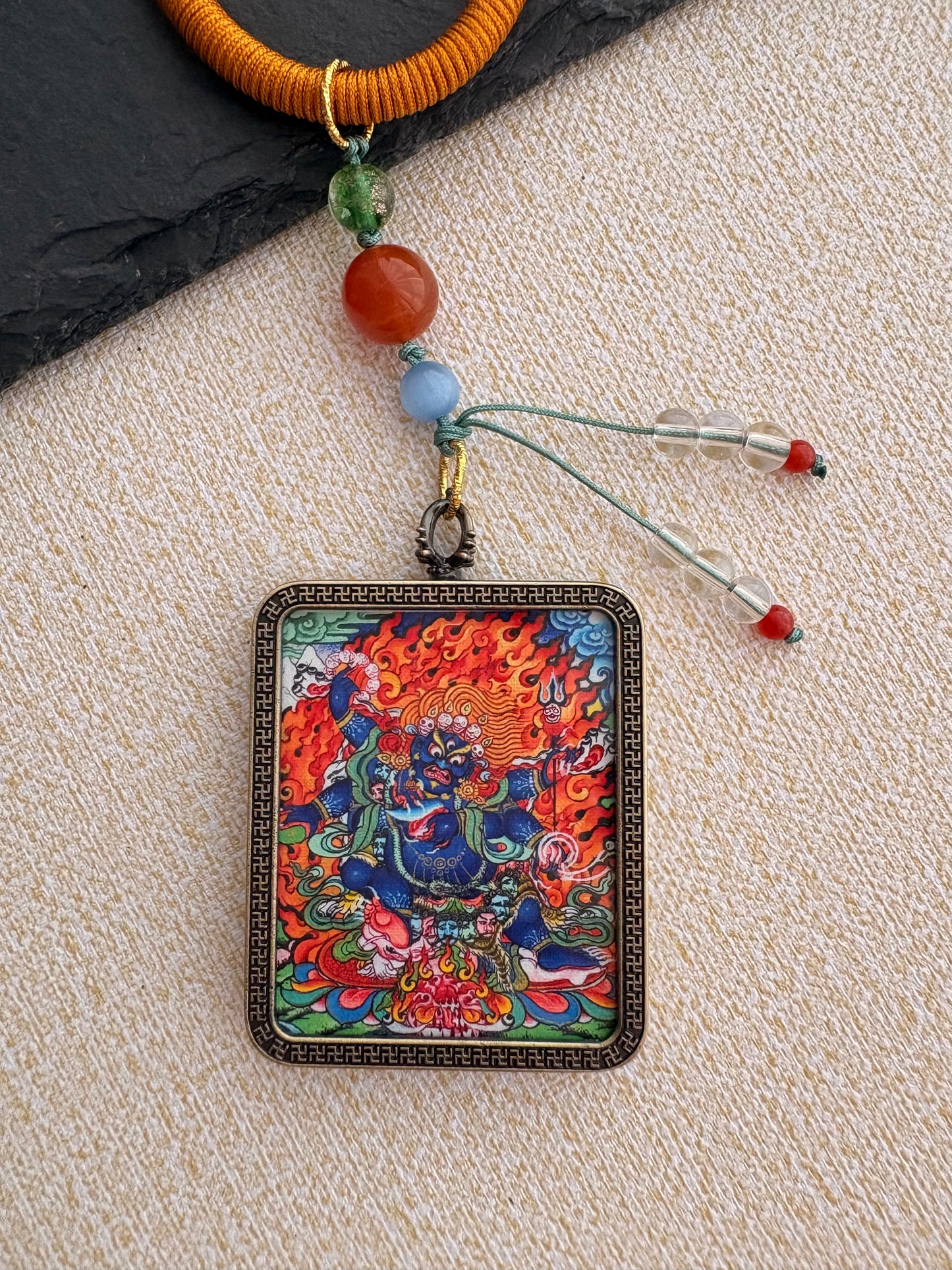 Mahakala Thangka Charm with Prayer Wheel Tassel in Tibetan Brown