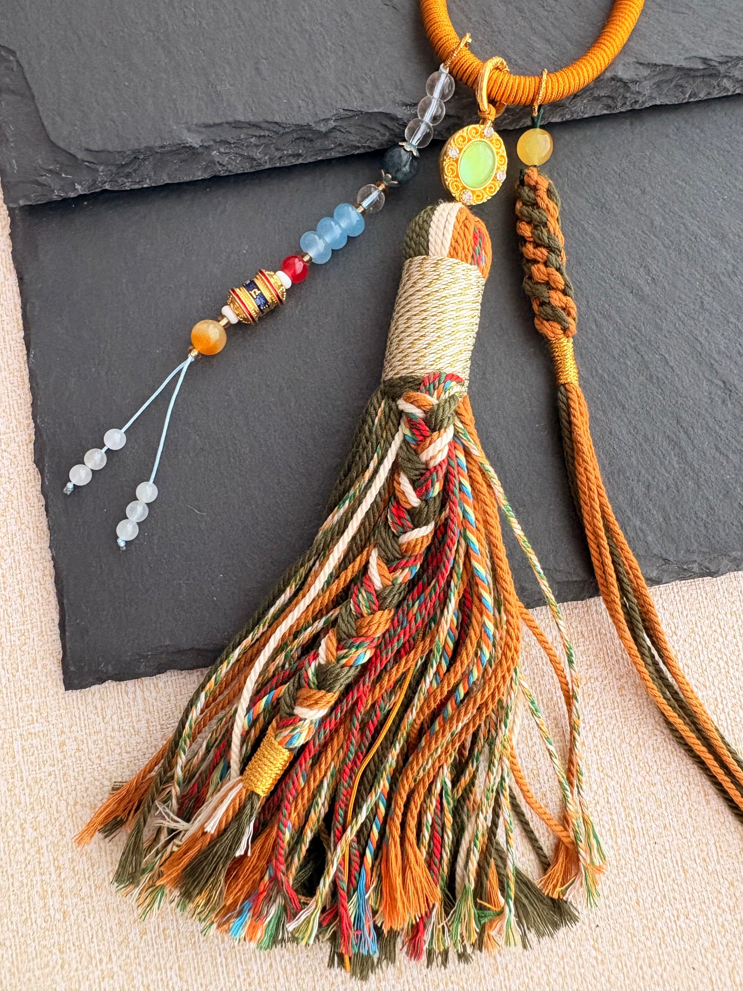Mahakala Thangka Charm with Prayer Wheel Tassel in Tibetan Brown