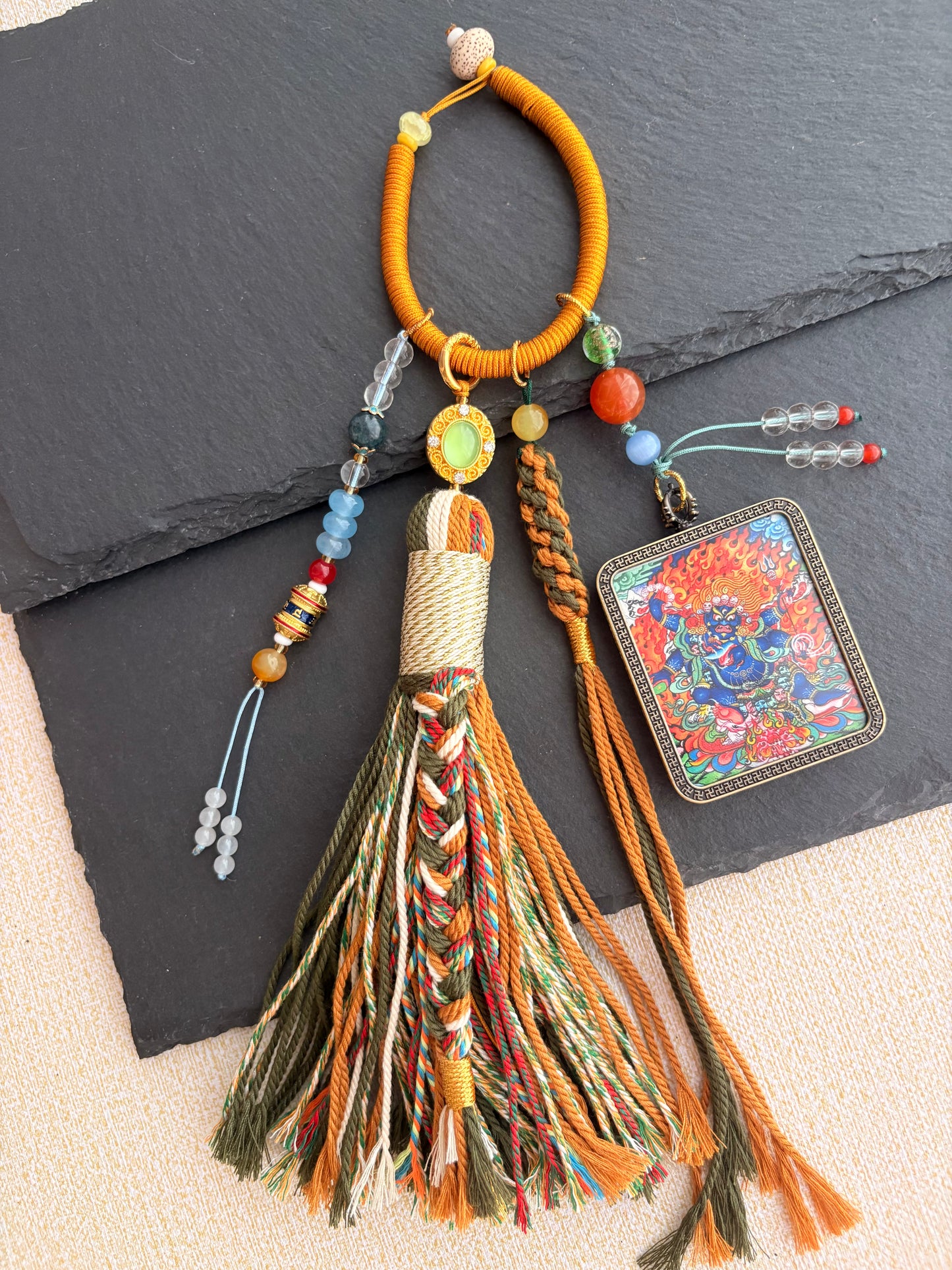 Mahakala Thangka Charm with Prayer Wheel Tassel in Tibetan Brown