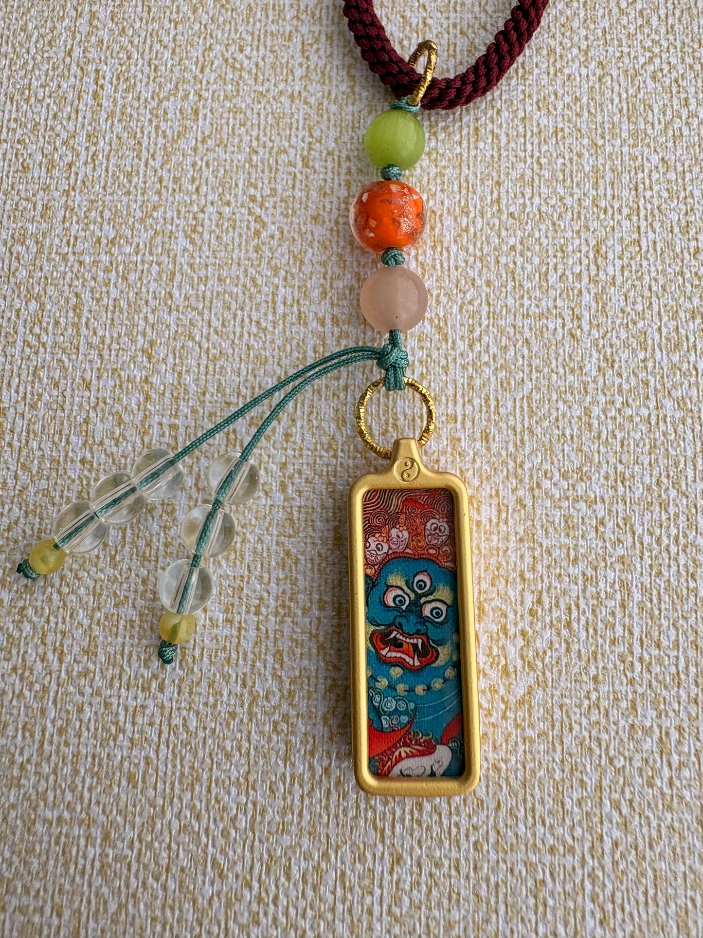 Small Mahakala Thangka Charm with Prayer Wheel Tassel in Tibetan Purple