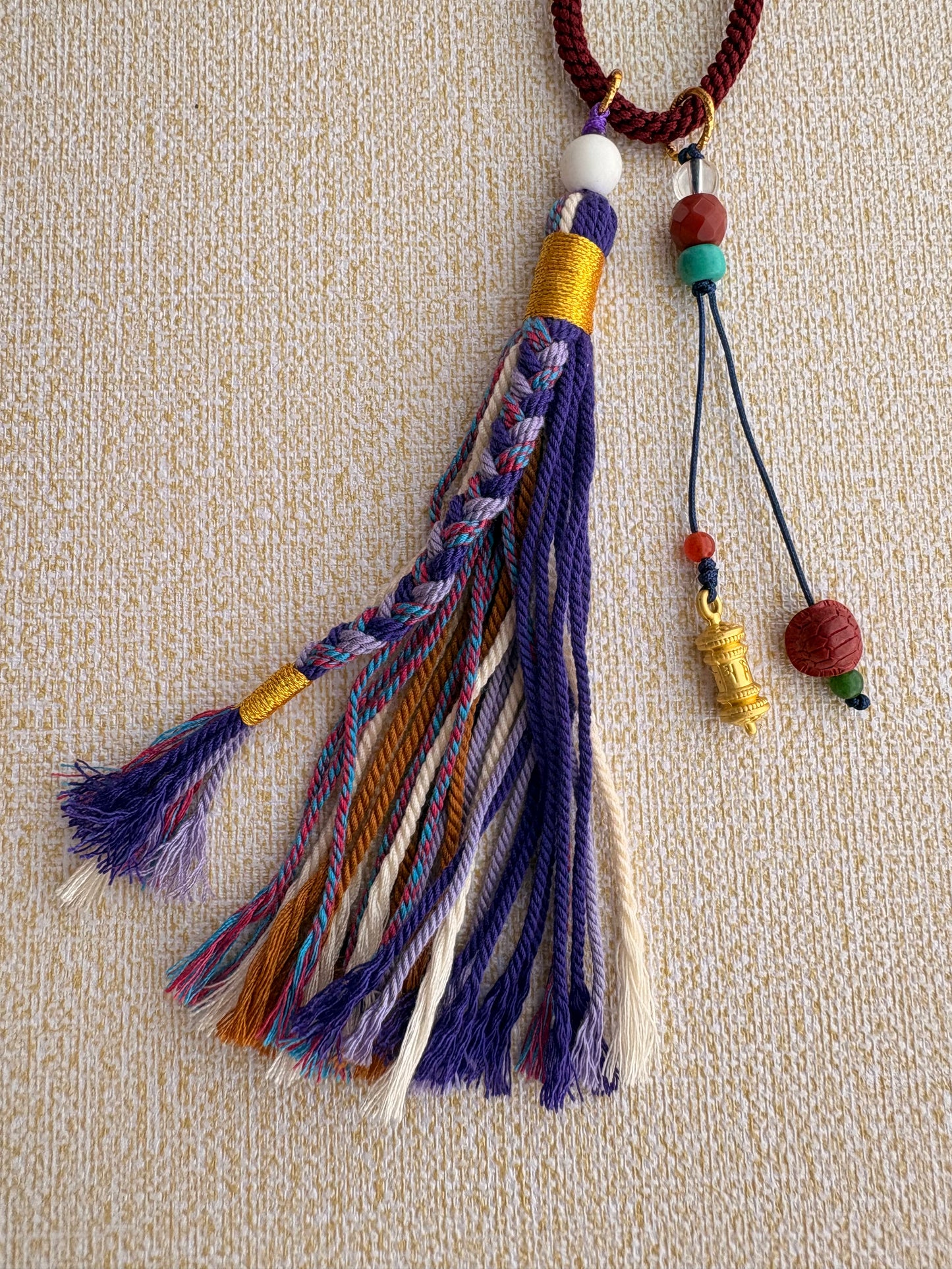 Small Mahakala Thangka Charm with Prayer Wheel Tassel in Tibetan Purple
