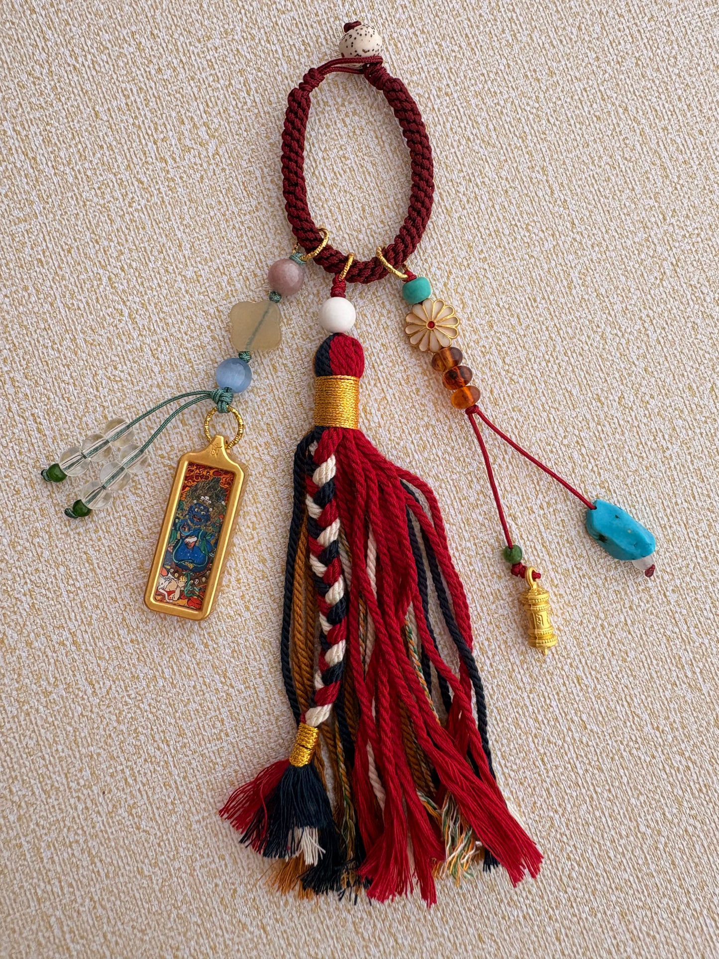 Small Mahakala Thangka Charm with Prayer Wheel Tassel in Tibetan Red