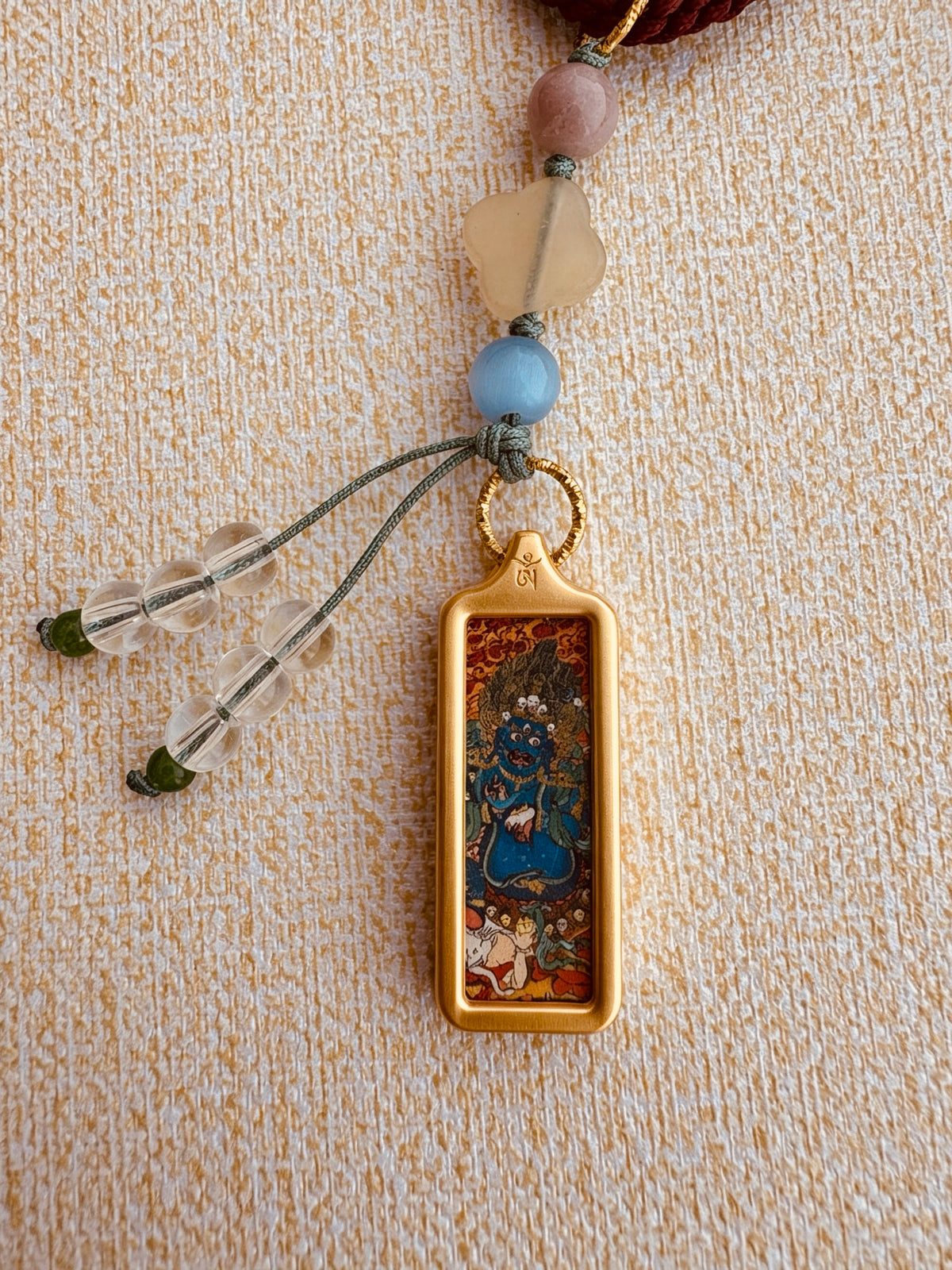 Small Mahakala Thangka Charm with Prayer Wheel Tassel in Tibetan Red