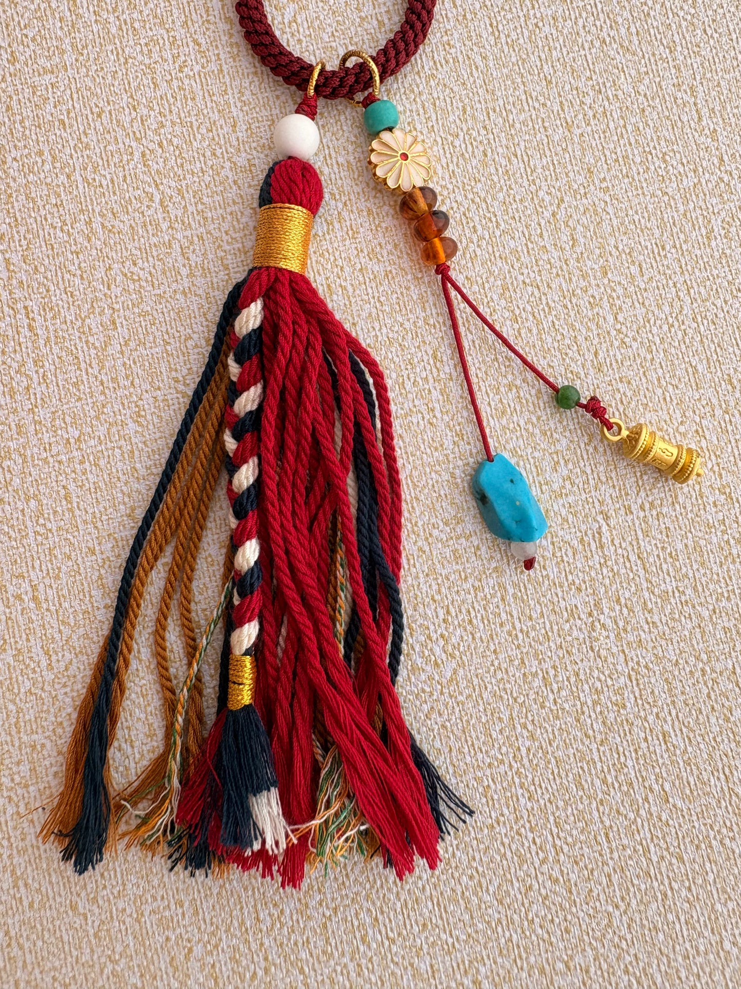 Small Mahakala Thangka Charm with Prayer Wheel Tassel in Tibetan Red