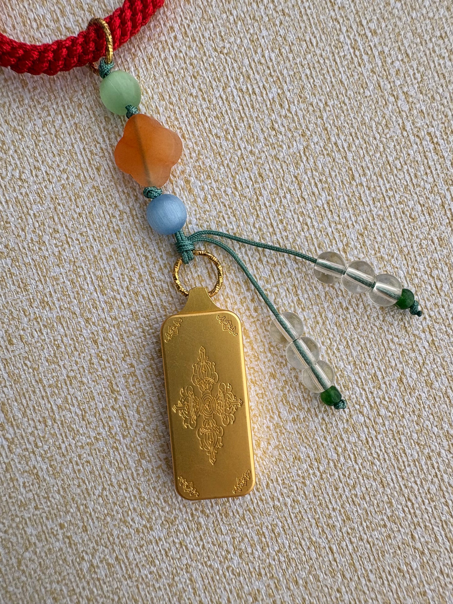 Small Yellow Jambhala Thangka Charm with Prayer Wheel Charm in Tibetan Red