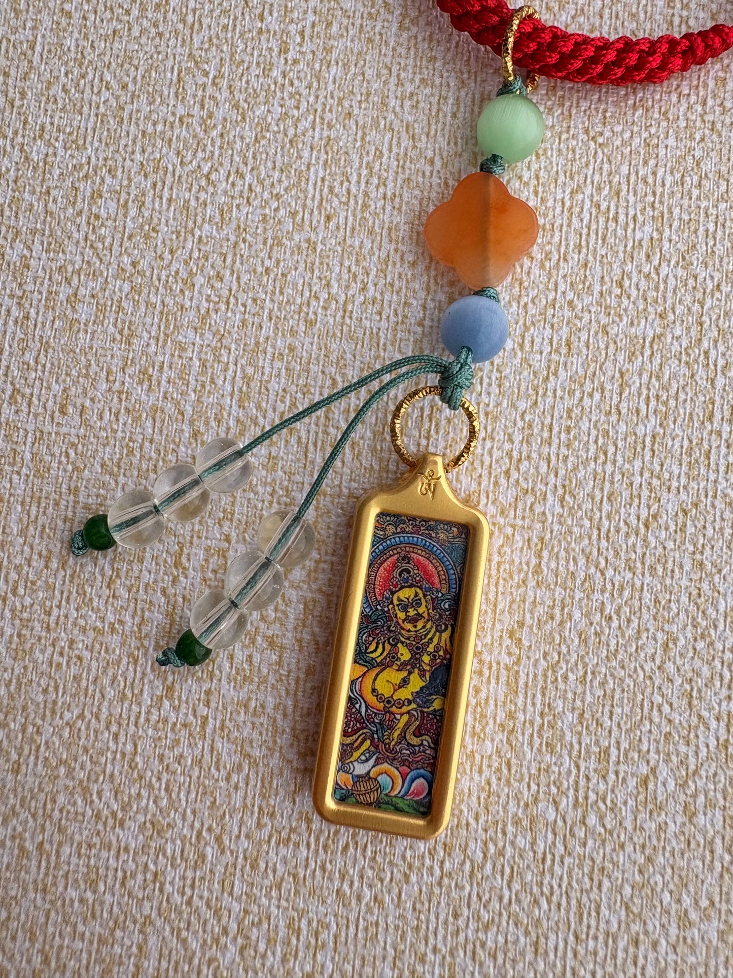 Small Yellow Jambhala Thangka Charm with Prayer Wheel Charm in Tibetan Red
