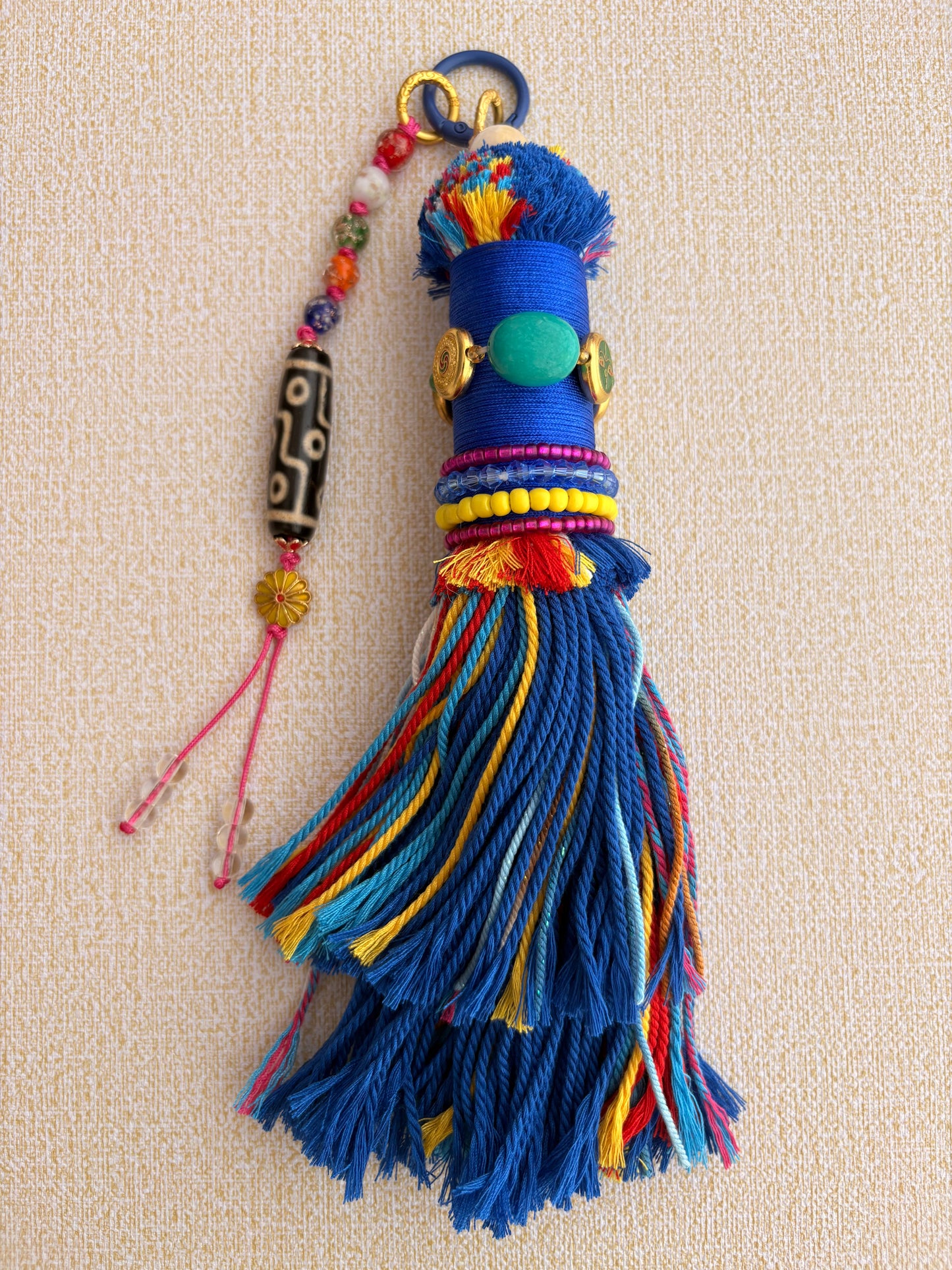 Victory Banner Charm with Nine-Eyed Dzi Bead Tassel in deep Tibetan Blue