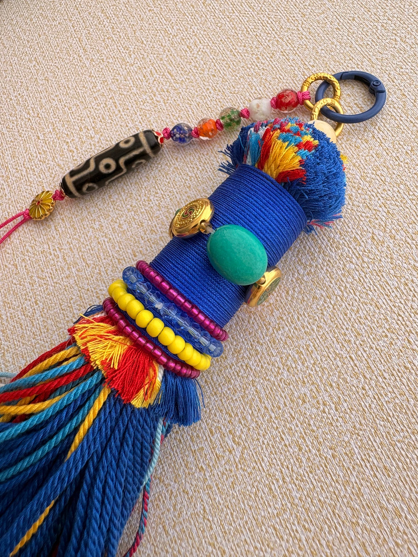 Victory Banner Charm with Nine-Eyed Dzi Bead Tassel in deep Tibetan Blue