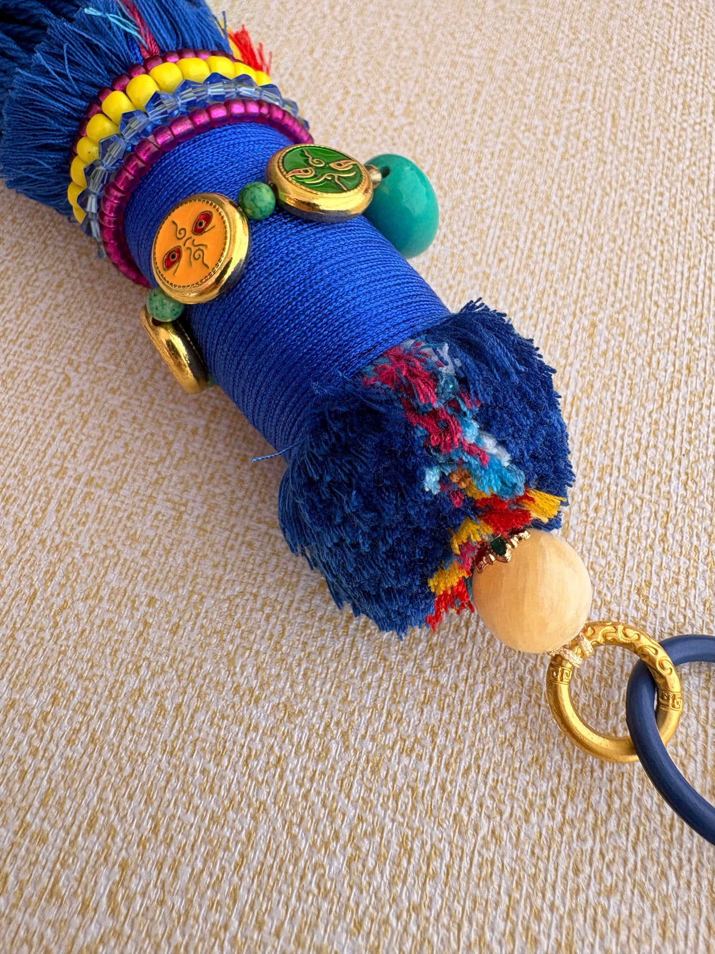 Victory Banner Charm with Nine-Eyed Dzi Bead Tassel in deep Tibetan Blue