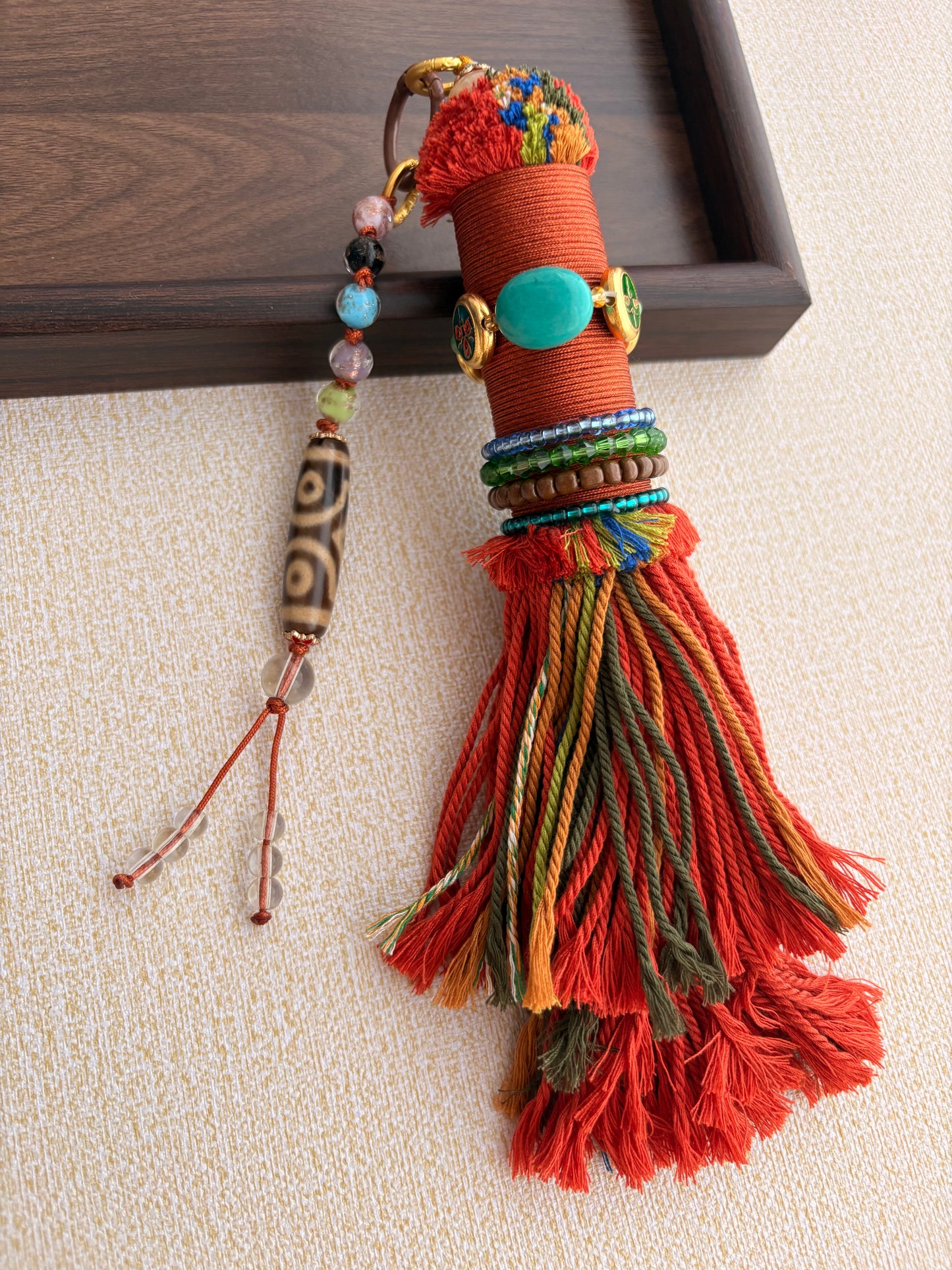 Victory Banner Charm with Three-Eyed Dzi Bead Tassel in Tibetan Orange
