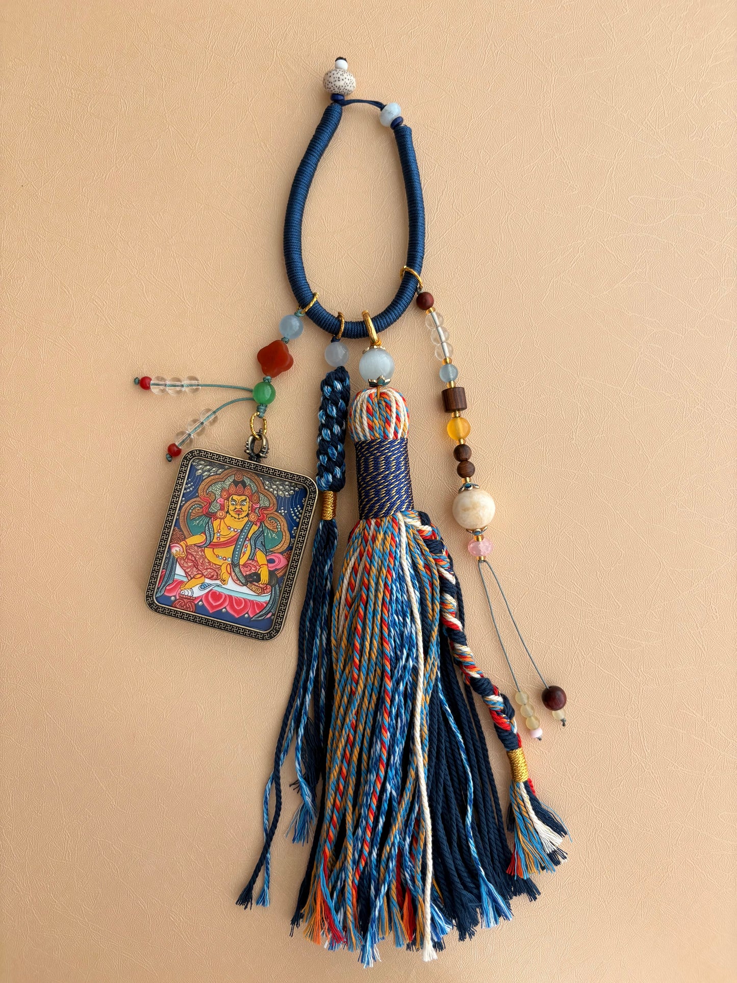 Yellow Jambhala Thangka Charm with Jade Tassel in Deep Tibetan Blue