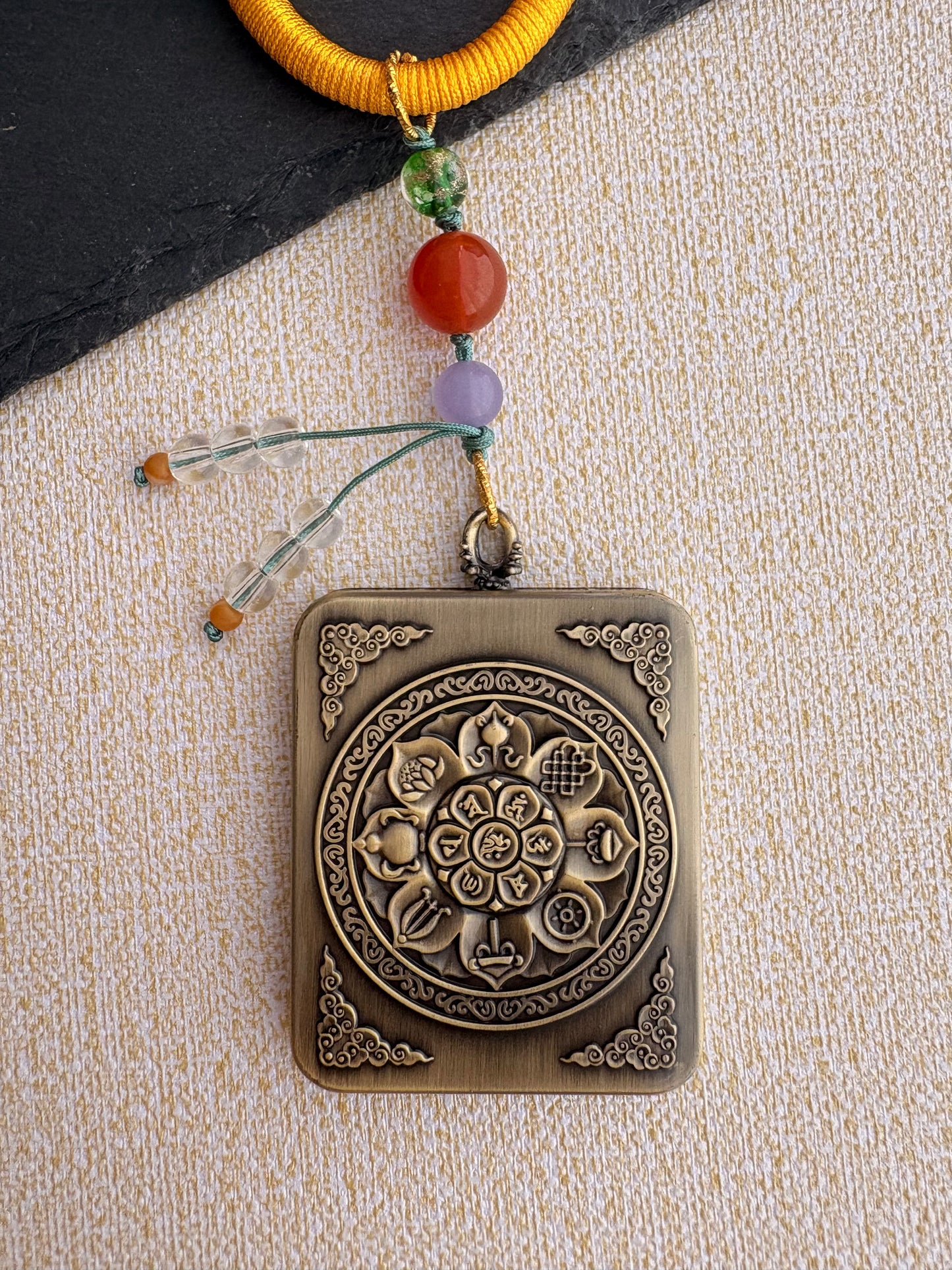 Yellow Jambhala Thangka Charm with Prayer Wheel Tassel in Tibetan Golden Yellow