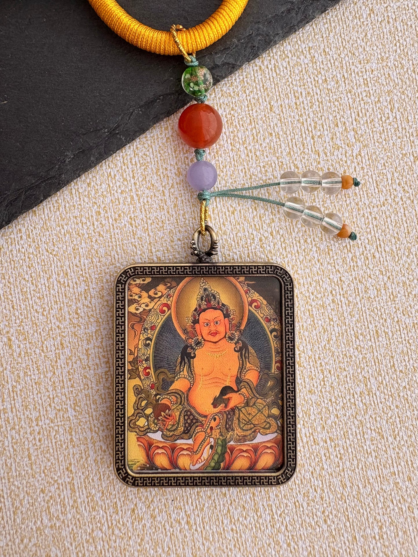 Yellow Jambhala Thangka Charm with Prayer Wheel Tassel in Tibetan Golden Yellow