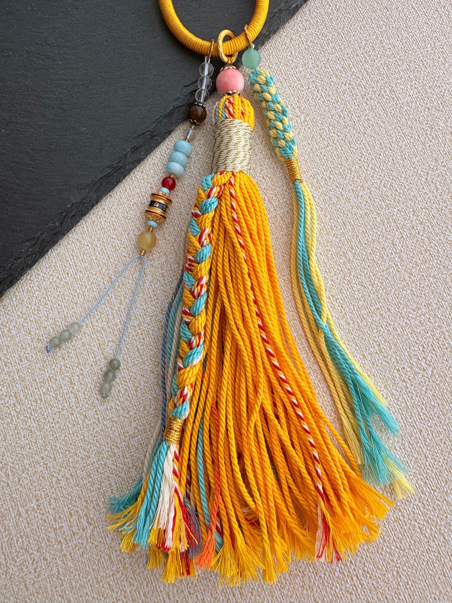 Yellow Jambhala Thangka Charm with Prayer Wheel Tassel in Tibetan Golden Yellow