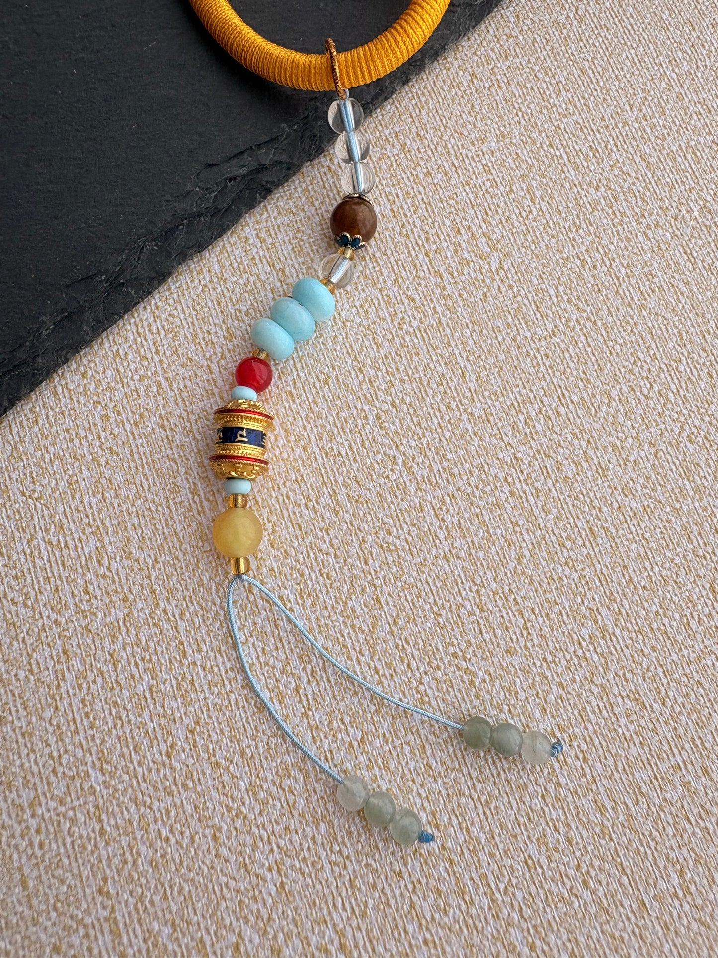 Yellow Jambhala Thangka Charm with Prayer Wheel Tassel in Tibetan Golden Yellow