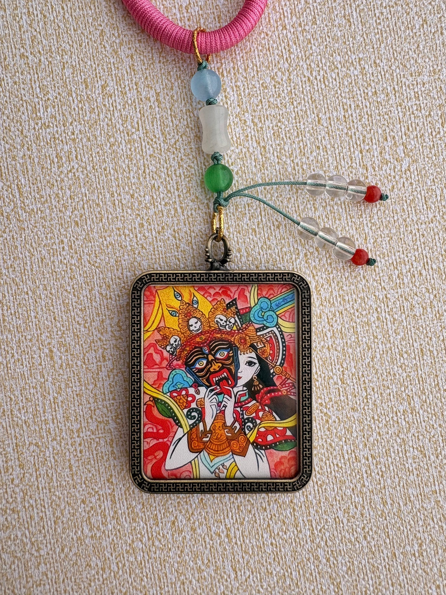 Zaki Lhamo Thangka Charm with Three-Eyed Dzi Bead Tassel in Tibetan Pink