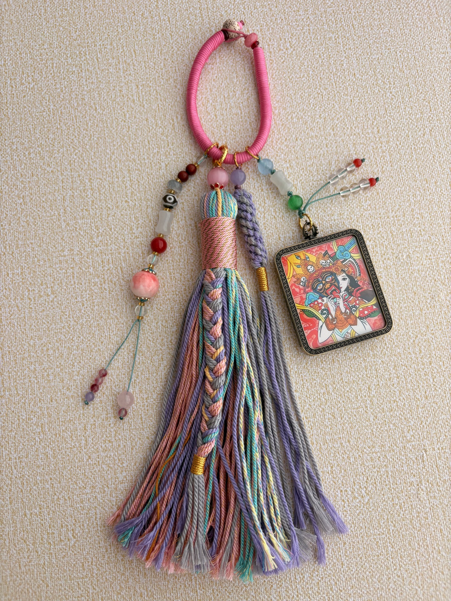 Zaki Lhamo Thangka Charm with Three-Eyed Dzi Bead Tassel in Tibetan Pink
